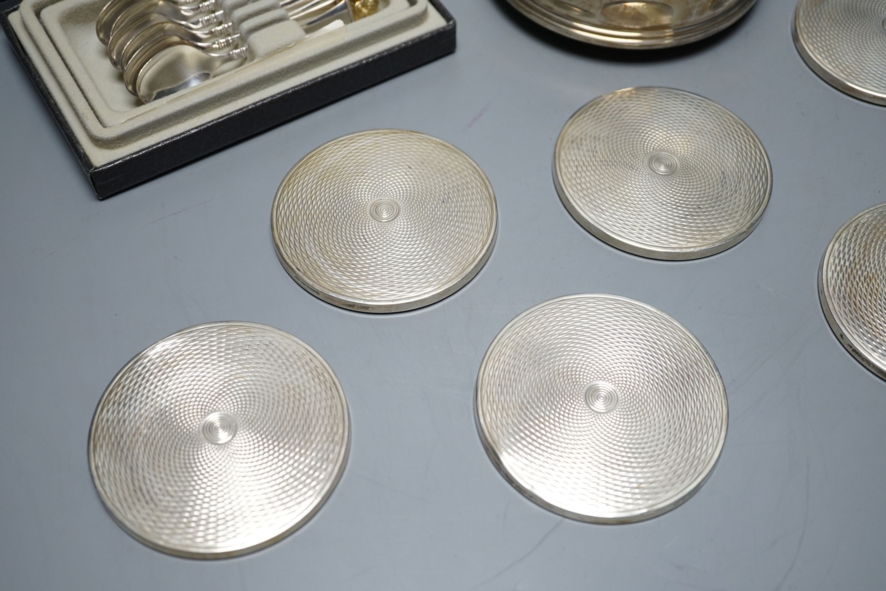 A cased set of six German 800 standard teaspoons by Robbe & Berking, a set of six silver mounted glass coaster and a modern silver mounted wine coaster.